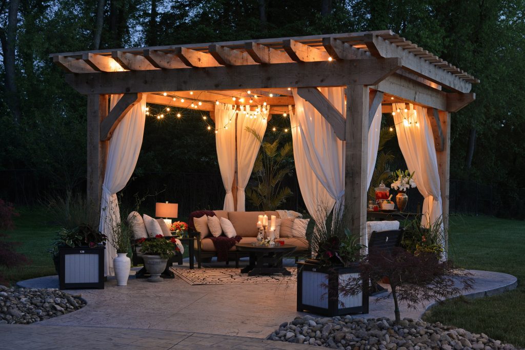 A hardscape design with a patio and pergola